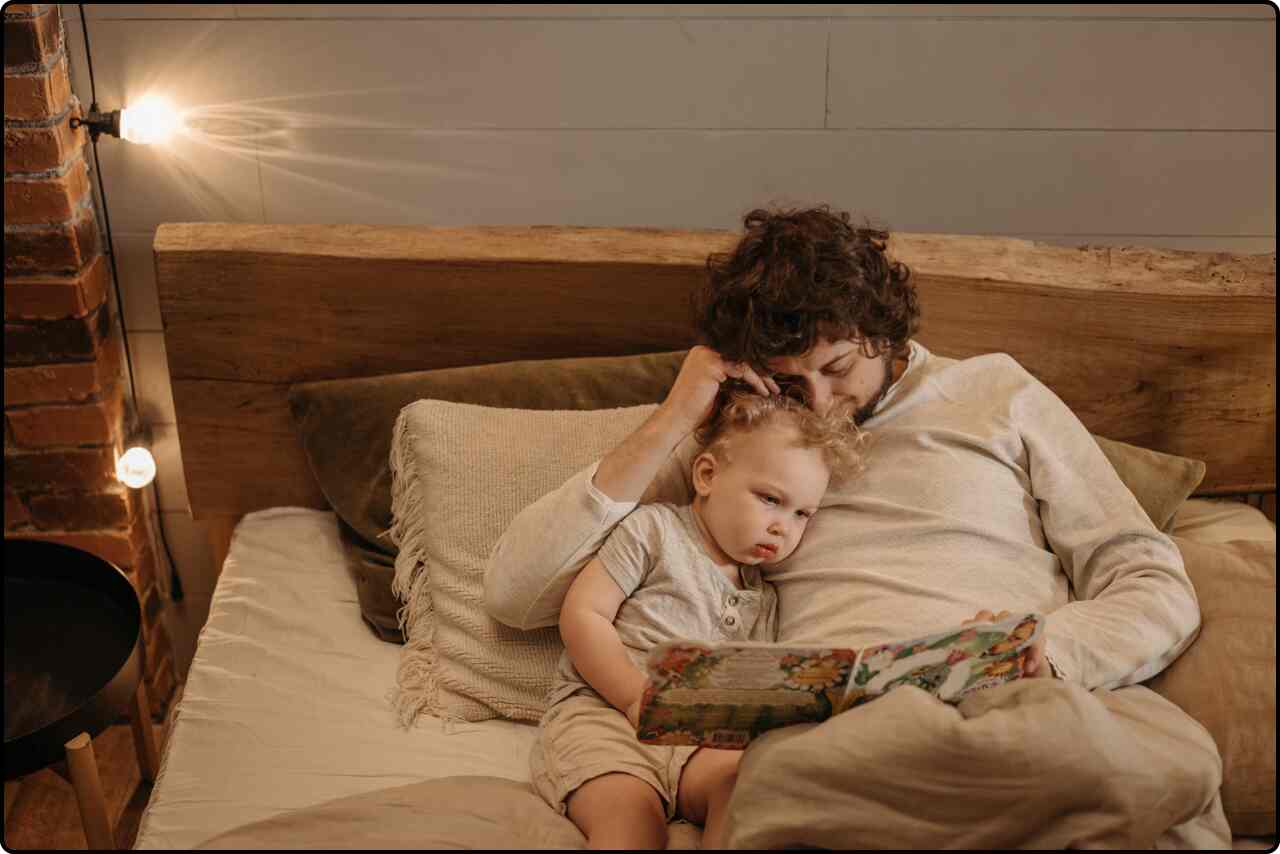 Father reading a bedtime story to his young child.